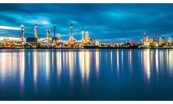 Panorama of Oil refinery with reflection from the river it sits next to.