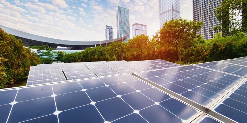 Solar panels on the rooftops of park buildings in a city.