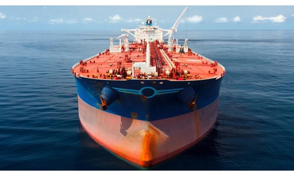 A close-up of a large red and blue oil tanker in the ocean.