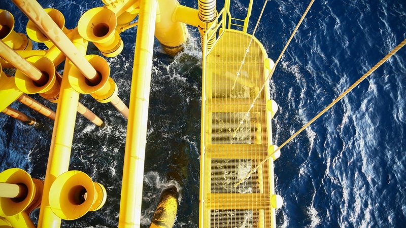 An aerial view of an oil rig in the ocean.