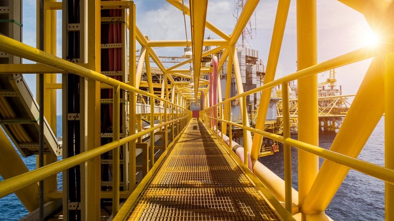 A view of the plat form connecting two sections of an oil rig at sea.
