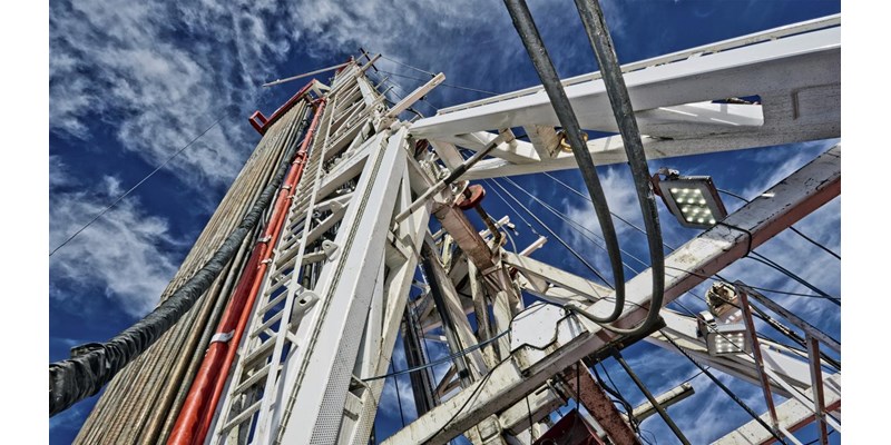 Central drilling column of an oil rig, against the blue skies.