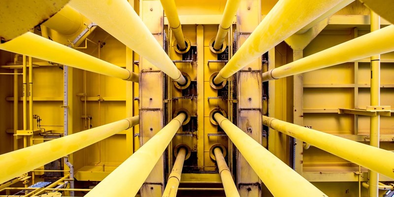A close-up of a yellow pipes on an oil rig.