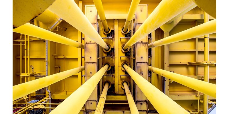 A close-up of a yellow pipes on an oil rig.