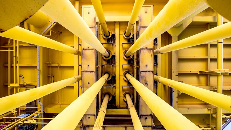 A close-up of a yellow pipes on an oil rig.