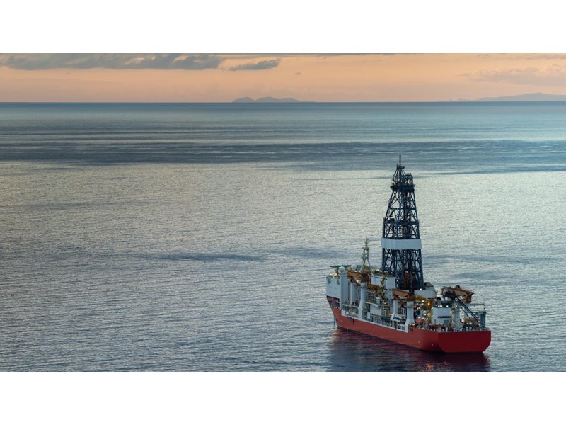 A large oil rig floating in the ocean.