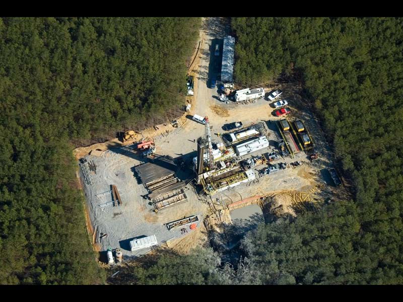 Onshore drill pad within forest