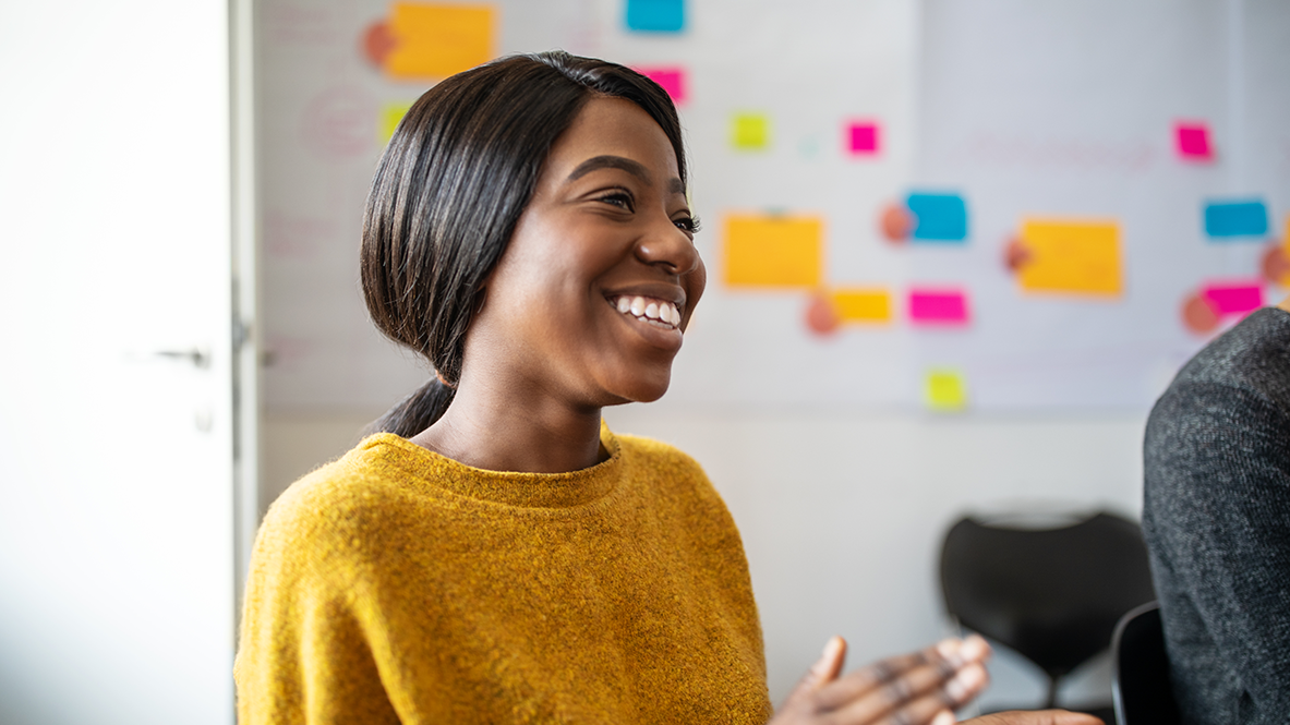 Marketing executive smiling during a conversation.